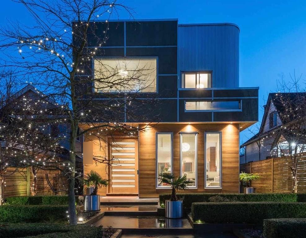 A contemporary Vancouver home at dusk, with winter lights in the trees