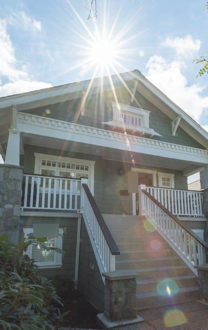 A Craftsman house with a covered front porch in Kitsilano