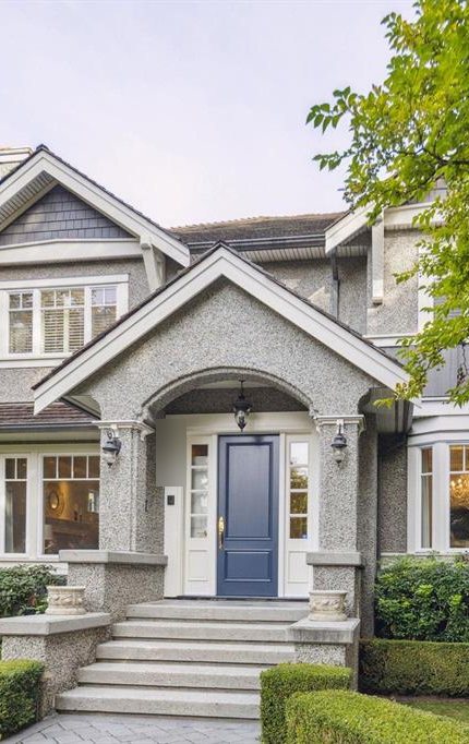 A traditional family home with a blue front door in Dunbar