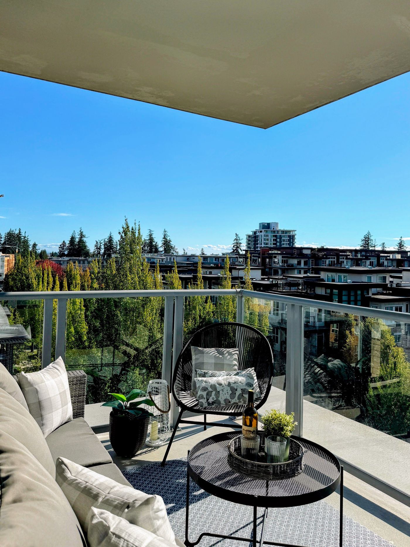 Condo balcony at UBC looking out over treetops on a clear day
